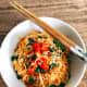 Place the noodles in a bowl. Garnish with thinly sliced peppers and fried shallots. Serve immediately.