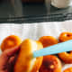 Using a drinking straw, pierce a small hole in the side of each doughnut.