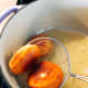 Take the donuts out and place them on a paper towel to drain the excess oil.