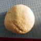 Transfer the dough onto a floured surface and continue kneading with your hands for another 10 minutes, or until it is smooth.