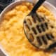 In a bowl, mash the bananas using a waffle head masher.