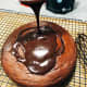 Pour the chocolate ganache on top of the cake. 