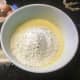Step 3: Add in the flour, vanilla extract, baking soda, salt, 1/2 cup sugar, zest and juice of lemons, and rose aroma. Mix together with a mixer. 