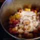 Add sugar to taste. 1/3 to 1/2 the volume of plums is average. Add any spices you wish along with the sugar, and stir thoroughly, mushing the plums with a wooden spoon. Use lid as required to build heat.
