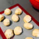 Place dough on a baking mat to deflate. Divide the dough into equal-sized balls (I made 12 balls).
