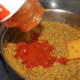 Adding pasta sauce
