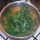 Prepared kale is added to simmering soup