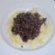 Haggis spooned on to mustard mash bed