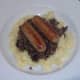 Chicken sausages are laid on haggis and mustard mash bed