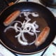 Frying chicken sausages and onion