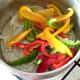 Sliced peppers are added to sauteed onion and garlic