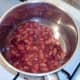 Beans are gently heated in a saucepan