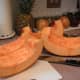 Continue to slice the quartered pumpkin into smaller sections.