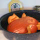 A turkey roasting pan works nicely to bake the quartered gourd.