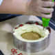 Covering the strawberries with vanilla mousse cream (Step 17).