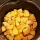 Fill pan with water, just enough to cover the top of the apples. Cook over medium heat until soft.