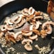 Add the sliced mushrooms into the pan.