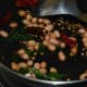 Add peanuts. Saute until they roast.