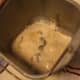 Softened yeast and warm water in the bread maker mold. Ready for the rest of the ingredients.
