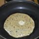 Step 2: In a flat-bottomed pan, add a few drops of oil. Heat it. Keep heat low. Place a papad on it. Gently press it with a spatula and roast it all over.