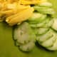 Thinly sliced cucumber, pineapple, and mango. 