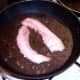 Bacon is fried in liver juices
