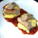 Sliced sausages are arranged on stuffed mushrooms