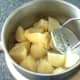 Butter is added to potatoes ready for mashing