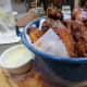 Smoked chili wings tossed in a black sauce and served with a creamy blue cheese dressing. Spicy and good!