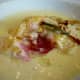 Cutting into the housemade raviolo (singular of ravioli)