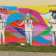 The "New Art Era" mural on Polk Street near the "We Love Houston" sculpture by David Adickes