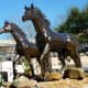 Horse sculptures in yard space in front of the restaurant