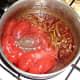 Tomatoes and seasonings are added to sauteed onions