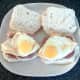 Spiced and sunny side up bread rolls are laid on top of corned beef