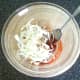 Sliced onion is added to spicy sauce