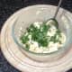 Chopped parsley is stirred in to mashed egg