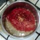 Tomatoes and chillies are added to sauteed garlic