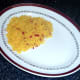 Chilli and turmeric rice is arranged on a serving plate.