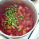 Peas are added to the curry.