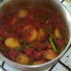 Potatoes are stirred through curry and re-heated.