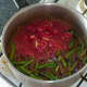 Tomatoes and chilli are added to spiced beans and onion