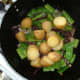 Cooked and cooled potatoes are added to onion and green beans