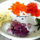 Chopped onions, chopped carrot, chopped cauliflower florets, chopped tomato, and green chillies.