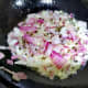 To the same pan add black mustard seeds and curry leaves. When it starts spluttering, add chopped onion.