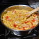 Bring the sauce to a gentle simmer and continue stirring until the onions are golden in color.