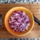 Dice the red onion and set it aside.
