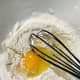 In a large bowl, combine the salt, pepper, cornflour, egg, and water. Stir to combine.