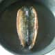 Mackerel fillet is turned in frying pan
