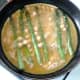 Beaten eggs are poured over asparagus and chickpeas