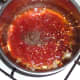 Tomatoes and chilli are added to sauteed garlic